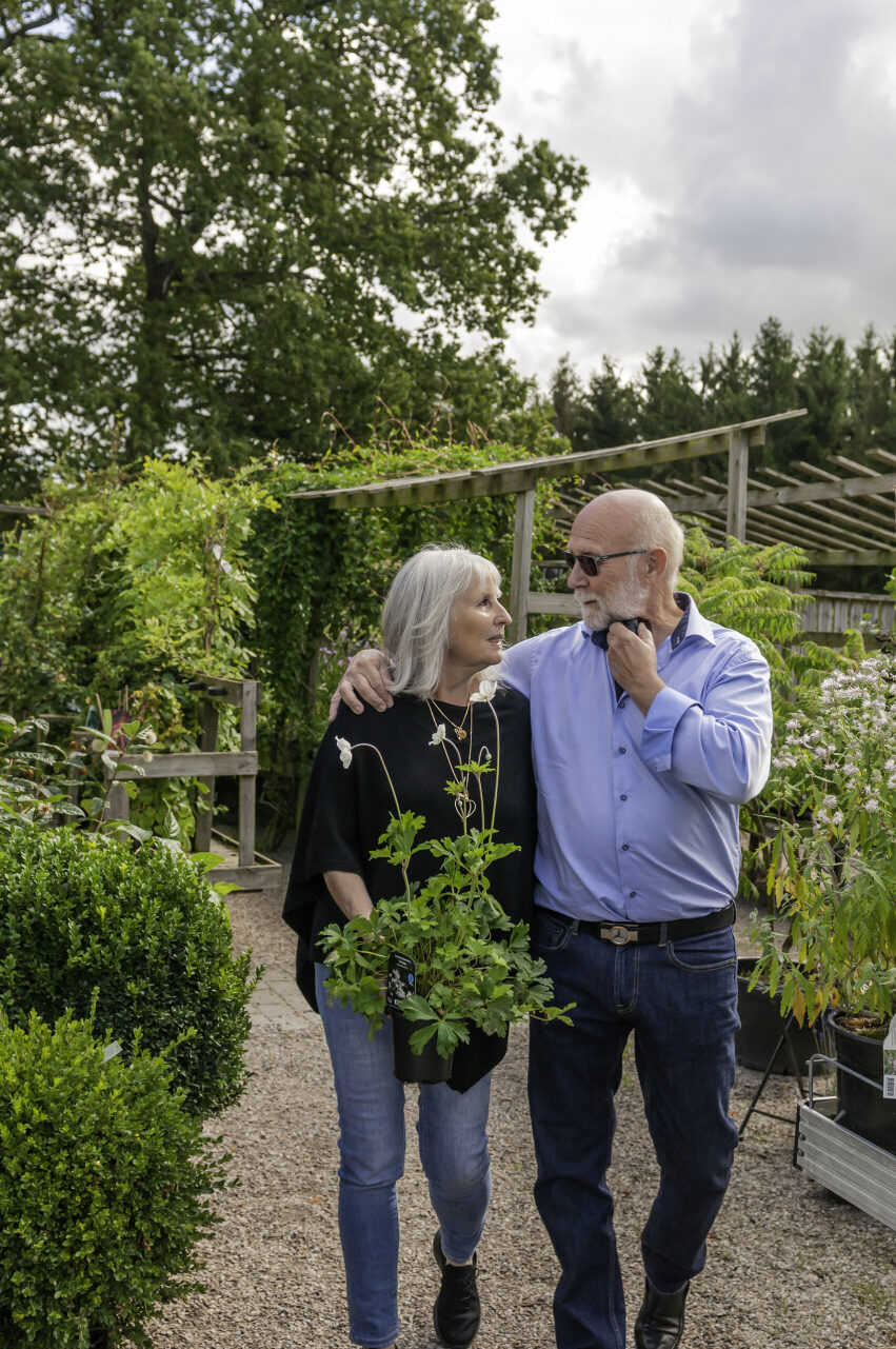 man an woman walking in garden outside